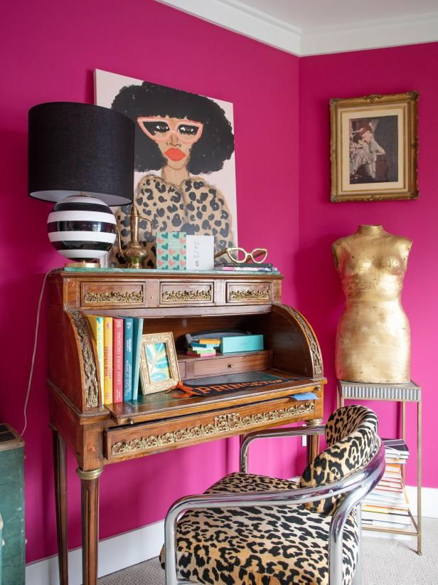 a pink room with a leopard print chair and an old piano in the foreground