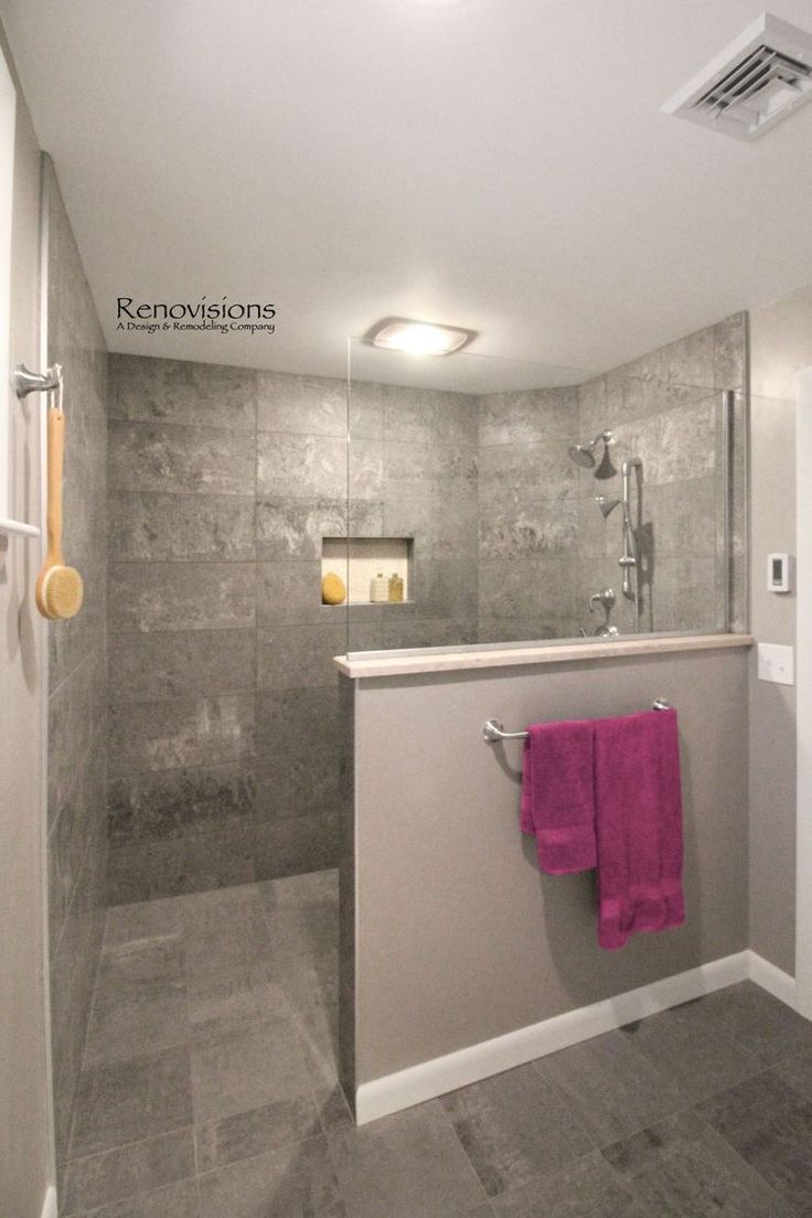 a bathroom with a sink, shower and towel rack