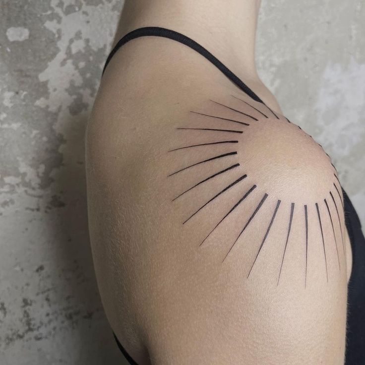 the back of a woman's shoulder with lines drawn on it and an arrow in the center