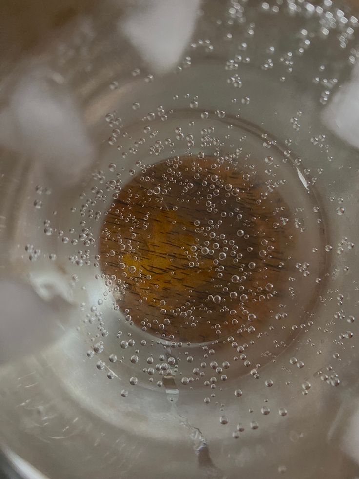 the inside of a glass bowl with water and bubbles on it, as seen from above