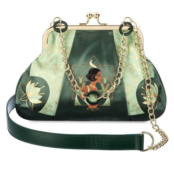 You'll know you're almost there when carrying this elegant satin handbag with vintage art deco styling. It features Tiana, lotus flowers, golden detailing and hardware, including a chunky link chain handle and a detachable shoulder strap. It's a perfect piece to set off your evening ensemble or dress up that everyday casual look. Black Disney Princess, Disney Lifestyle, Disney Princess Tiana, Satin Purses, Dooney And Bourke Disney, Disney Dooney, Disney Handbags, Princess And The Frog, Princess Tiana