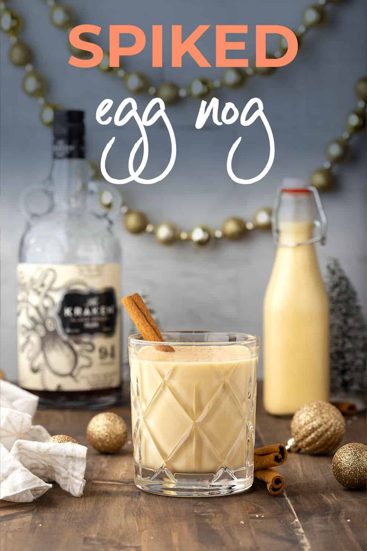 an egg nog drink in a glass with cinnamon sticks