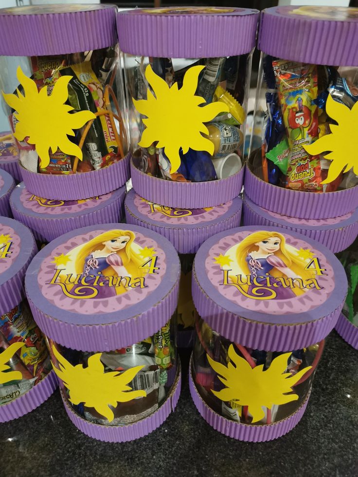 there are many purple plastic containers with princesses on them