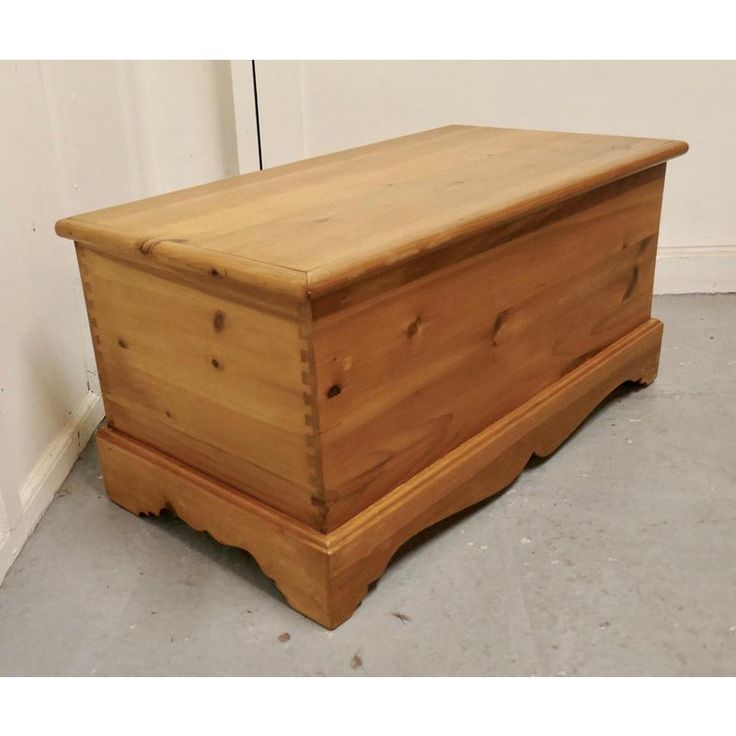 a wooden chest sitting on top of a floor