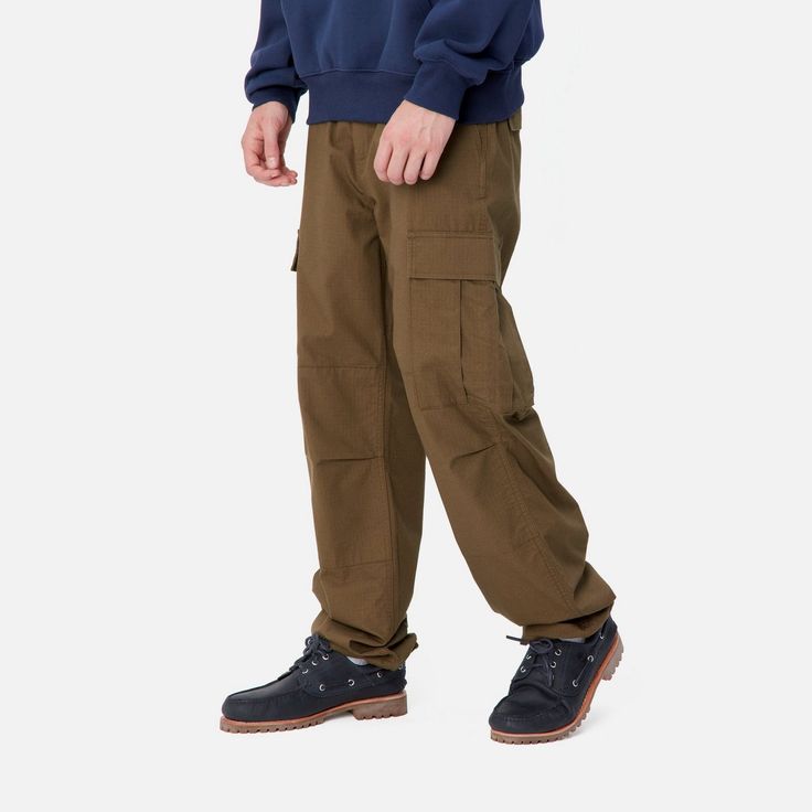 Color: Chocolate - The Regular Cargo Pant is made of midweight cotton Columbia ripstop, which has been rinsed for a softer feel. The style is cut in a regular fit with a low waist and features double-layer knees, adding to its robust qualities. Multiple pockets throughout nod to the garment's military-style influences, and tie detailing at the cuffs allow for the fit to be adjusted. The Aviation Pant () offers the same lightweight quality construction with a slimmer fit. _* Columbia ripstop: 100 Relaxed Fit Cotton Cargo Jeans For Outdoor, Cotton Cargo Jeans For Outdoor, Urban Cotton Pants For Outdoor, Full Length Cotton Cargo Pants For Outdoor, Outdoor Full-length Cotton Pants, Outdoor Cotton Work Pants With Cargo Pockets, Winter Cotton Cargo Pants, Full Length, Straight Leg Cotton Parachute Pants For Outdoor, Urban Style Cotton Work Pants For Outdoor