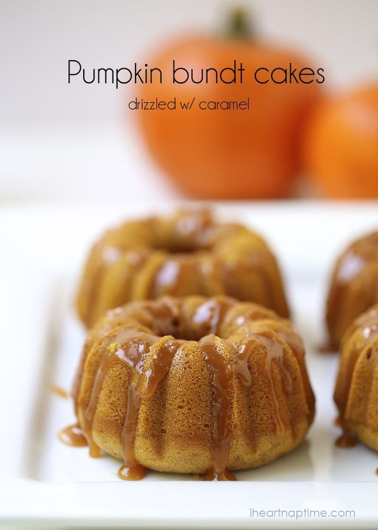 pumpkin bundt cakes with caramel glaze on a white plate next to oranges