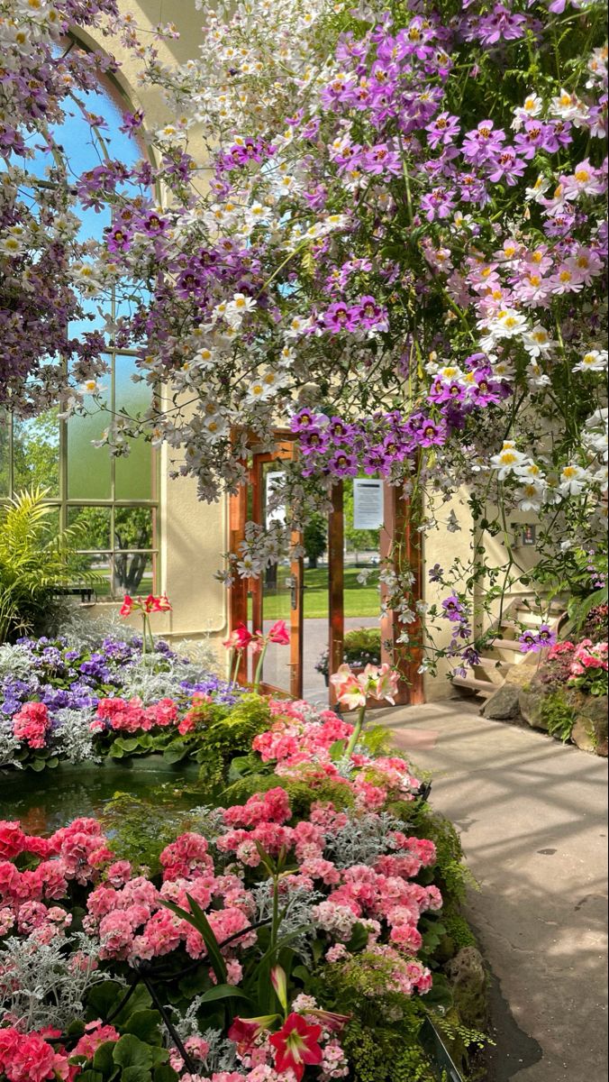 the inside of a building with many different types of flowers