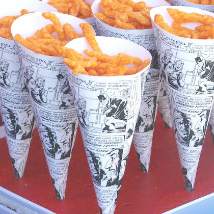 several cones filled with cheetos sitting on top of a table