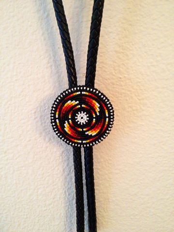 a black and red beaded necklace hanging on a wall