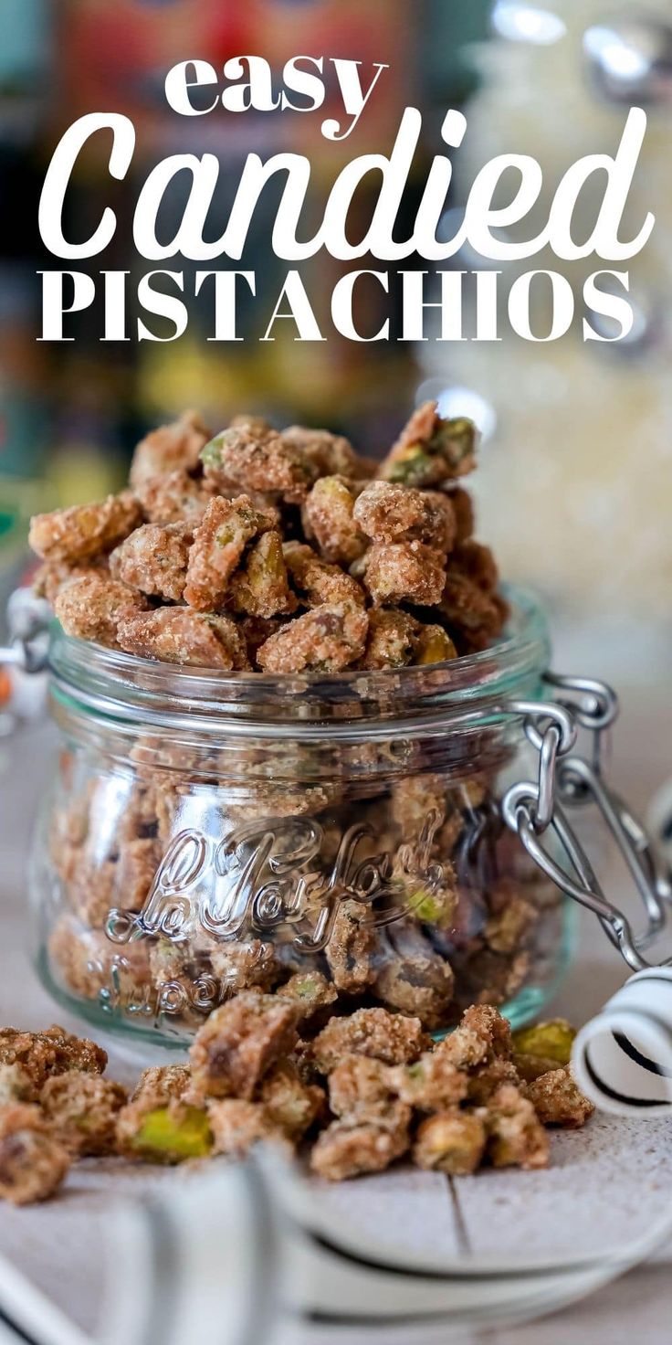 a glass jar filled with candied pistachios on top of a table