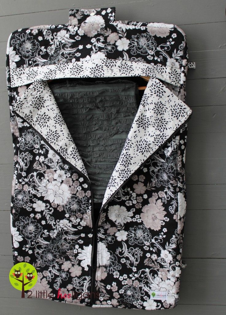 a black and white floral jacket hanging on a wall