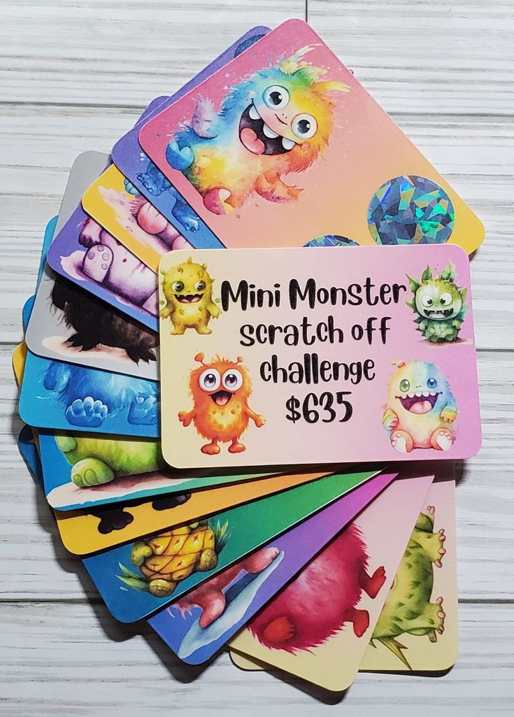 a bunch of cards that are sitting on top of a wooden table with the words mini monster scratch off challenge $ 695