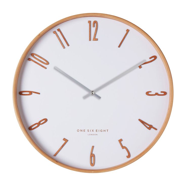 a white clock with brown numbers on the face is shown in front of a white background