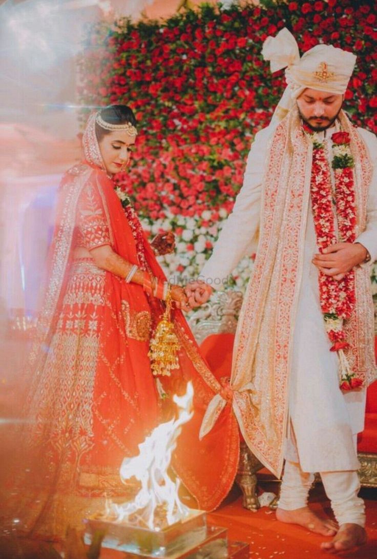 the bride and groom are standing next to each other