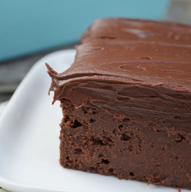 a piece of chocolate cake sitting on top of a white plate