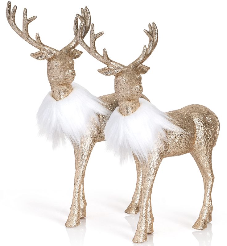 two gold reindeer figurines with white fur and antlers on their heads, standing next to each other