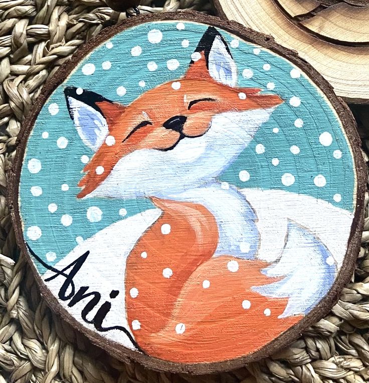 a painted wood slice with a fox on it