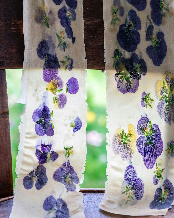 the curtains are decorated with purple flowers