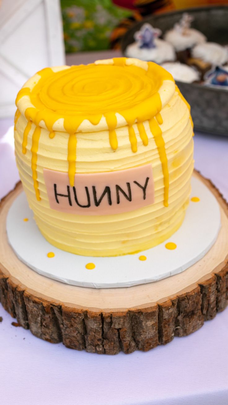 a cake that is sitting on top of a wooden slice with the word humong written on it