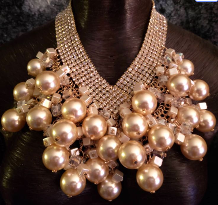 This sexy, Hollywood glamour massive bib statement necklace is a vintage piece from my personal collection. It has enjoyed many a black tie event but now it needs a new home. I will point out that it is missing one rhinestone and jump ring in the back which could easily be repaired by a jeweler. This flaw is built into the price point. The faux pearls are off white with a gold undertone. Scattered among them are clear and creamy lustrous cubes. These are attached to a rhinestone bib which adjusts from 18-21" and has a gold tone lobster claw clasp and 3" extender chain. Overall the piece is in EXCELLENT vintage condition with the exception of the noted flaw. Presented by Kat Kouture. Necklaces Inspiration, Rocker Chic Accessories, Oversized Necklace, Celebrity Stylist, Unique Pendant Necklace, Necklace Art, Statement Bib Necklace, Chest Piece, Mermaid Necklace