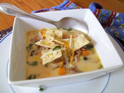 a white bowl filled with soup and tortilla chips