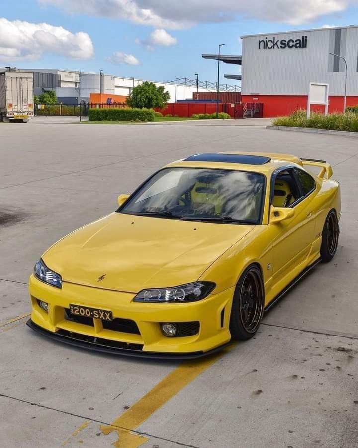 a yellow sports car parked in a parking lot