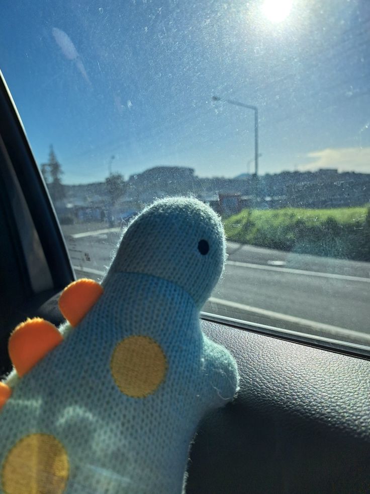 a stuffed animal sitting in the passenger seat of a car