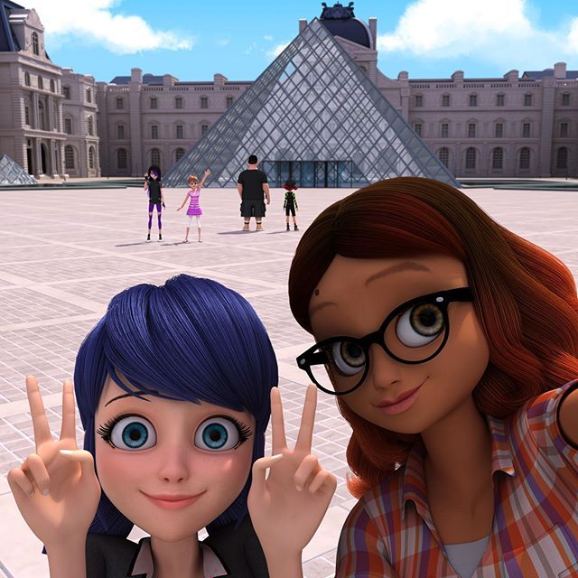 two animated women are making the peace sign in front of a building with pyramids