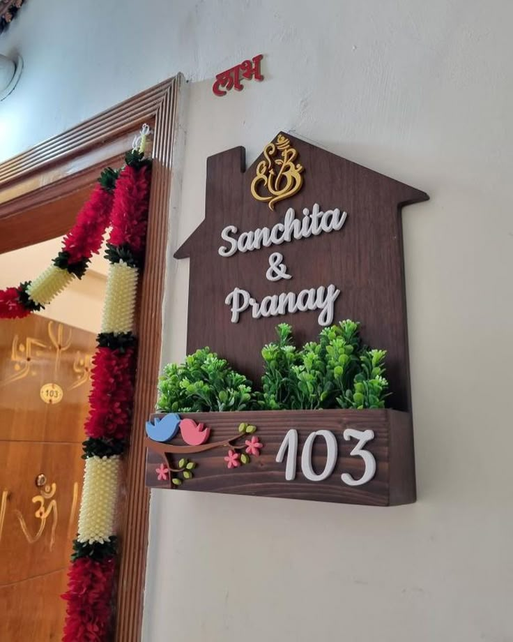 a wooden sign that says sanchita and pranay on the side of a building