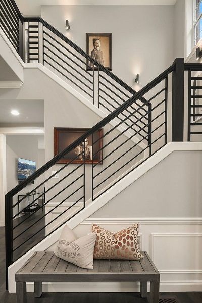 the stairs in this house have been painted white and are decorated with black railings