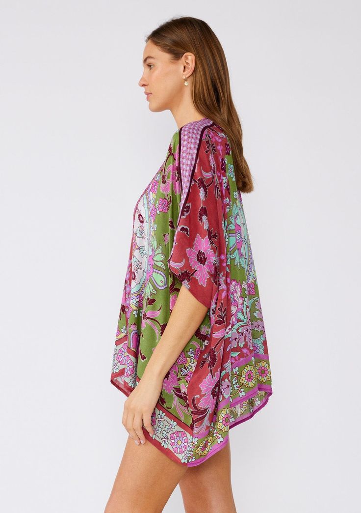 An ultra-bohemian kimono top in a stunning green and pink floral print. Floral print with contrast border Relaxed fit Half-length kimono sleeve Open front Bohemian style cover-up A must-pack style for the beach or your next vacation. Our lightweight kimono top is designed in a gorgeous mixed floral print. With an easy open front and half-length sleeves. Throw it on over your swimsuit for a quick cover-up, or style it over jeans shorts and a tank top for an effortlessly bohemian vibe. ﻿ Model is Bohemian Green Tunic Kimono, Multicolor Floral Print V-neck Kimono, Multicolor V-neck Kimono With Floral Print, Green Bohemian Short Sleeve Kimono, Green V-neck Bohemian Kimono, Bohemian Green V-neck Kimono, Green Tunic Kimono For Beach Cover-up, Green Bohemian Kaftan With Floral Print, Patterned Kaftan For Spring