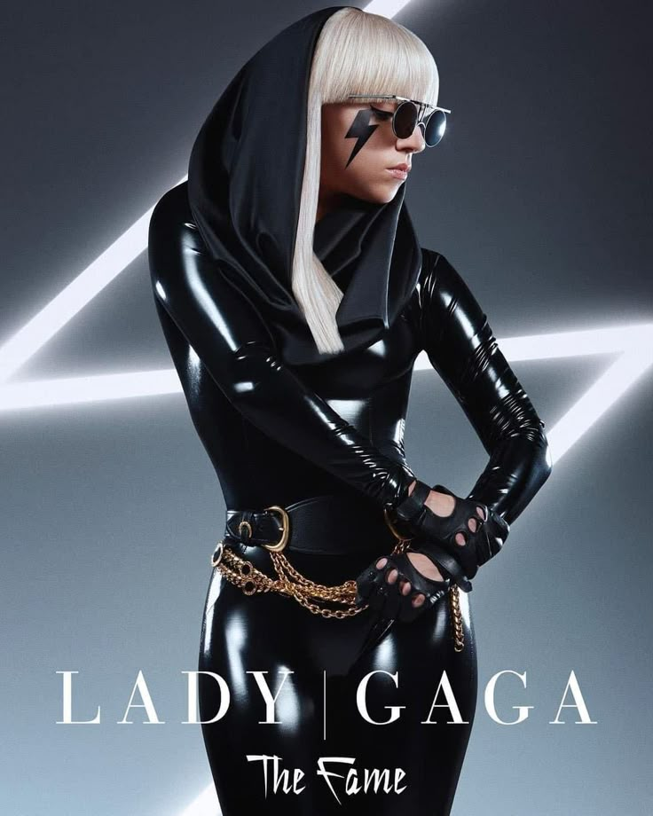 lady gag the fame album cover art with black catsuits and gold chains on her body