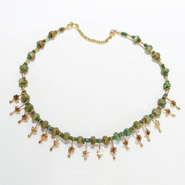 A fine Etruscan Revival style necklace.  By the New York City Modernist female goldsmith Resia Schor.   In 14k gold.  Set with an alternating series of rough cut jade beads and stylized flower & bird gold drops on a gold wire and secured with a 14k gold safety catch.  Designed with stylistic elements of the work of Resia's husband, Ilya Schor, Cubism, and Brutalism. Incorporating these elements in addition to a strong nod to the design of ancient jewelry of the Mediterranean, Resia Schor's work Artisan Gold Necklace With Dangling Beads, Artisan Gold Beaded Necklaces With Gemstone Beads, Artisan Gold Beaded Necklaces With Dangling Beads, Gold Jade Beaded Necklaces With Gemstone Beads, Artisan Gold Beaded Necklaces With Spacer Beads, Artisan Gold Necklaces With Spacer Beads, Gold Jade Beaded Necklaces With Gemstones, Artisan Gold Necklace With Gemstone Beads, Artisan Gold Necklace With Polished Beads