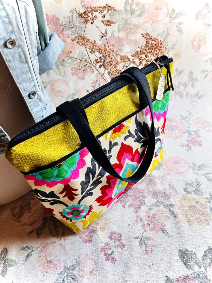 An elegant framed desert floral design with strong Spanish influence. A heavy cotton linen in a colorful Suzani patterned print- same design but different color way from our Santa Monica. The bright colors are artfully showcased against a sandy background. A great shape for a roomy carry-all, the Atenti Satchel has a 18” zippered opening and double 30" straps. The inside is fully lined in water resistant taffeta and has a zippered pocket and an open divided pocket with a cell phone slot. Dimension: 19.00"W x 14.00"H x 5.50"D Sandy Background, Tunisian Hooks, Interchangeable Knitting Needles, Crochet Hook Set, Circular Knitting Needles, Crochet Kit, Circular Knitting, Santa Maria, Instagram Shop