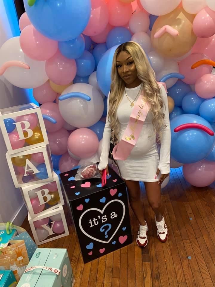 a woman standing in front of balloons and presents