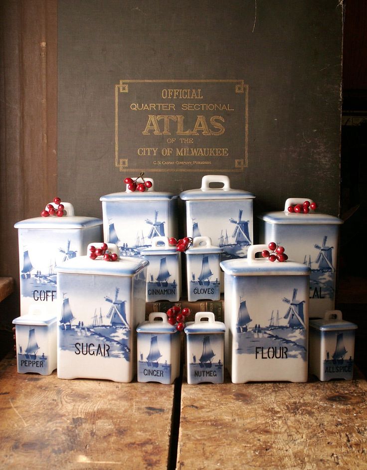 a group of blue and white containers sitting on top of a wooden table next to a sign