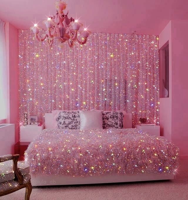 a bedroom with pink walls and lights on the ceiling, bed in front of a chandelier