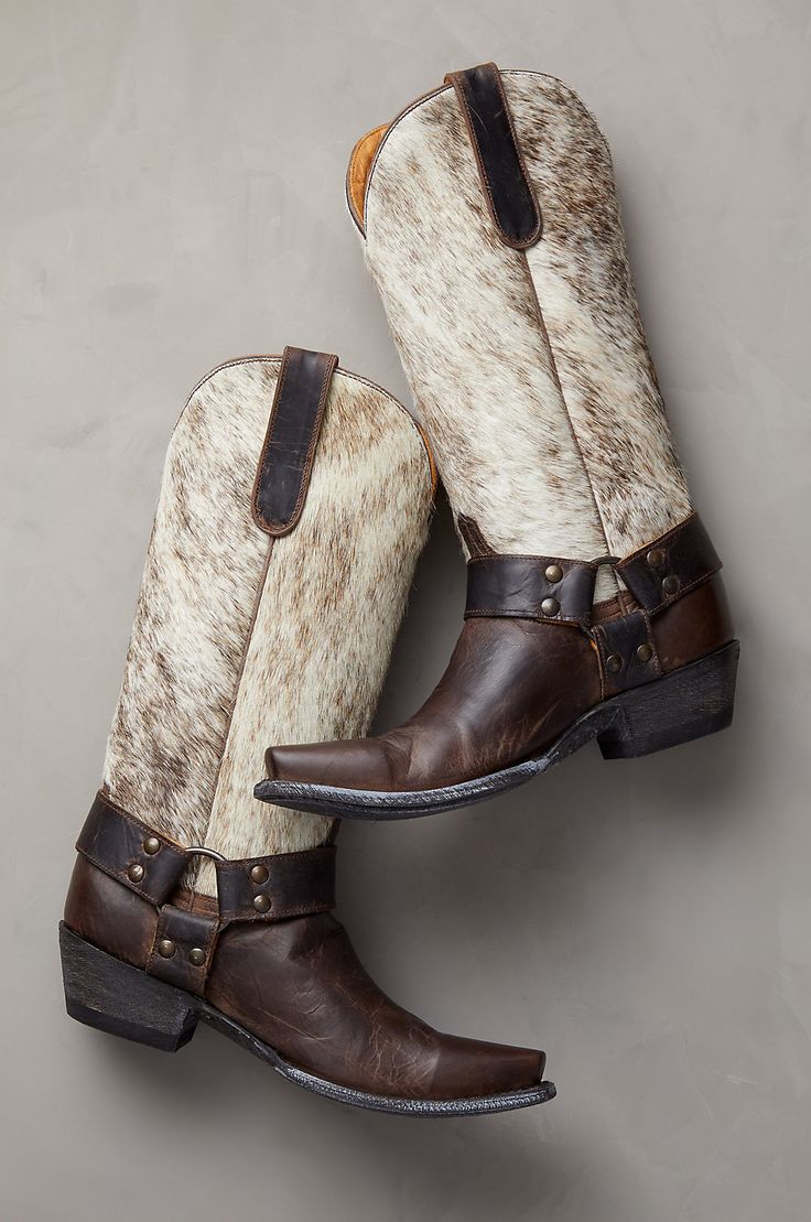 With their unique rugged beauty, no-holds-barred western style, and rich combination of textures, the Florence leather boots are an unforgettable addition to your wardrobe. These handcrafted kicks feature goatskin leather uppers and hair-on cowhide shafts, with goatskin pullstraps for easy wear. Strappy harness detailing with studs adorns each side of the boot, while leather heels and outsoles offer a durable step. With calfskin leather lining, cushioned footbeds, and welt construction. Cowhide Boots, Tall Western Boots, Tall Western Boot, Cowboy Boots For Women, 2024 Wardrobe, Girl Boots, Stylish Footwear, Handmade Boot, Leather Cowboy Boots