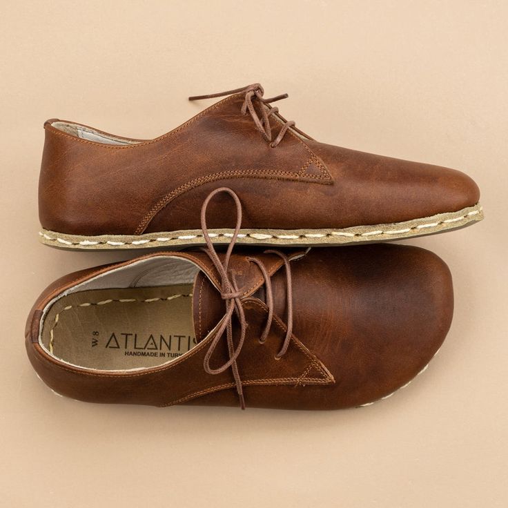 Our Atlantis Handmade Women's Lion Oxford shoes combine high-quality leather and traditional shoemaking skills. It is only through our know-how and belief in barefoot shoes, a wealth of experience, and the best materials that we are able to create this unique and top-quality shoe. Barefoot Sandals Women, Hair Doos, Barefoot Boots, Brown Slippers, Black Boots Men, Shearling Slippers, Know How, Brown Oxfords, Shoes Stand