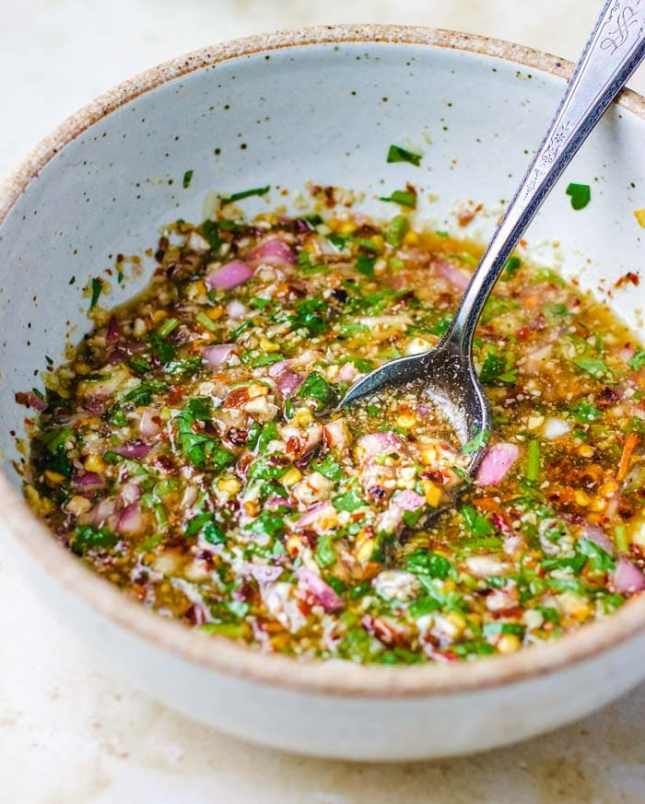 a white bowl filled with food on top of a table