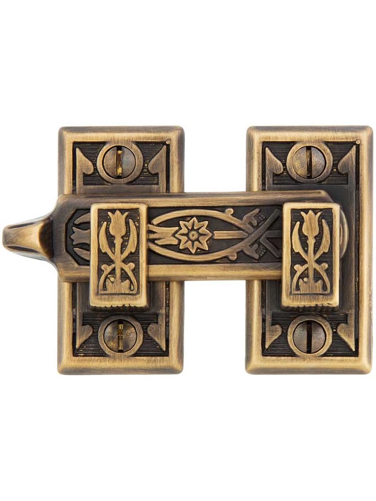 an antique brass door handle with decorative designs