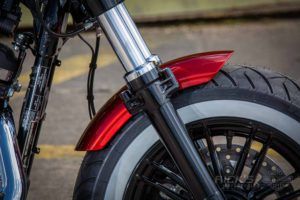 the front end of a motorcycle parked on a street