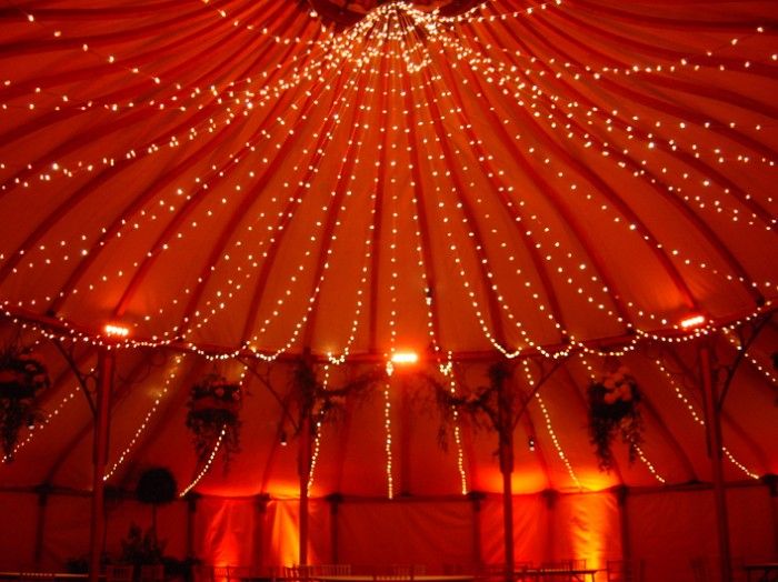 the inside of a large tent with lights on it