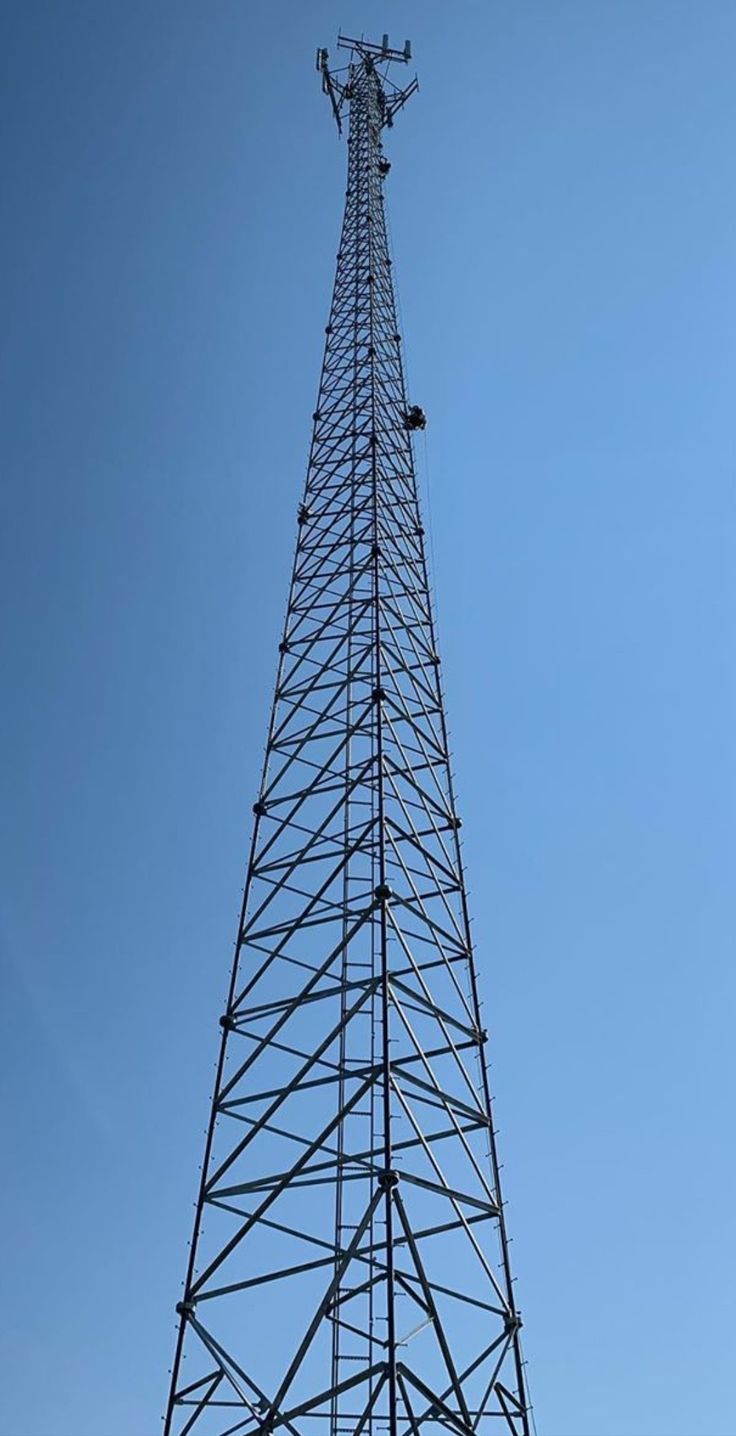 a tall metal tower sitting under a blue sky