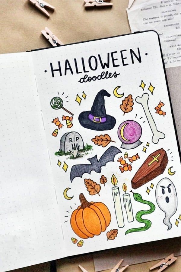 an open notebook with halloween doodles on it