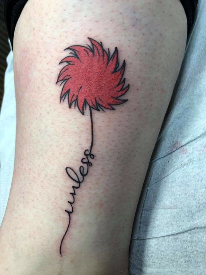 a woman's leg with a red flower tattoo on her left calf and the word love written in cursive writing