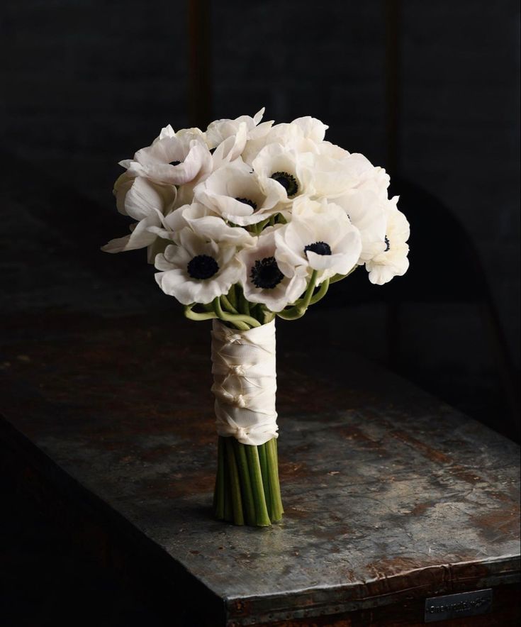 a bouquet of white flowers sitting on top of a table