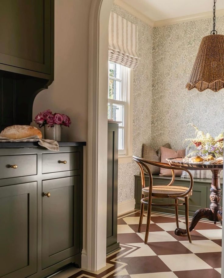 a dining room table and chairs in front of a checkered wallpapered floor