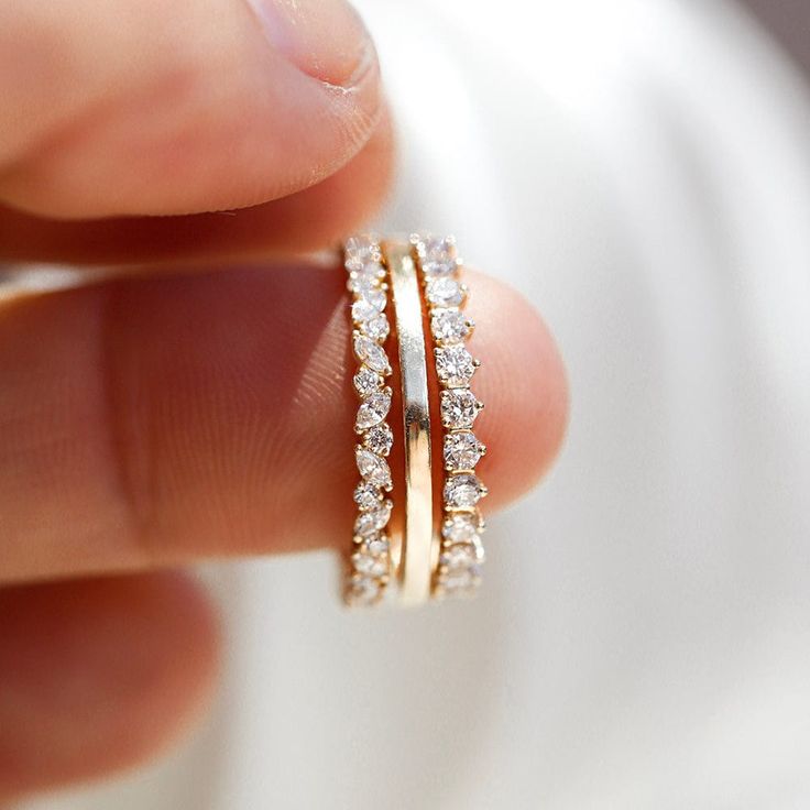 The 1.5mm Flat Band is a dainty golden band with a square edge finish. Elegant in its proportions, this ring offers a beautiful, gleaming addition to your collection with its unique, yet classic look. The 1.5mm Flat Band is the perfect addition of texture to any stack, but you can also easily stack three up on their own for extra shine. This is a versatile piece that will give you extra shimmer no matter how you wear it! 14k Rose Gold Stackable Eternity Band, Stackable 14k Rose Gold Eternity Band, Gold Stackable Princess Cut Diamond Rings, Gold Stackable Rings With Princess Cut Diamonds, Timeless Stackable Yellow Gold Couple Rings, Everyday Rose Gold Diamond Ring With Prong Setting, Everyday Gold Eternity Band With Prong Setting, Gold Diamond Ring With Princess Cut And Half Eternity, Stackable Yellow Gold Couple Rings In Fine Jewelry Style