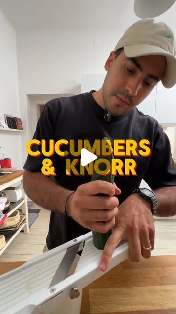 a man in a black shirt and hat working on a piece of wood with the words cucumbers & korr